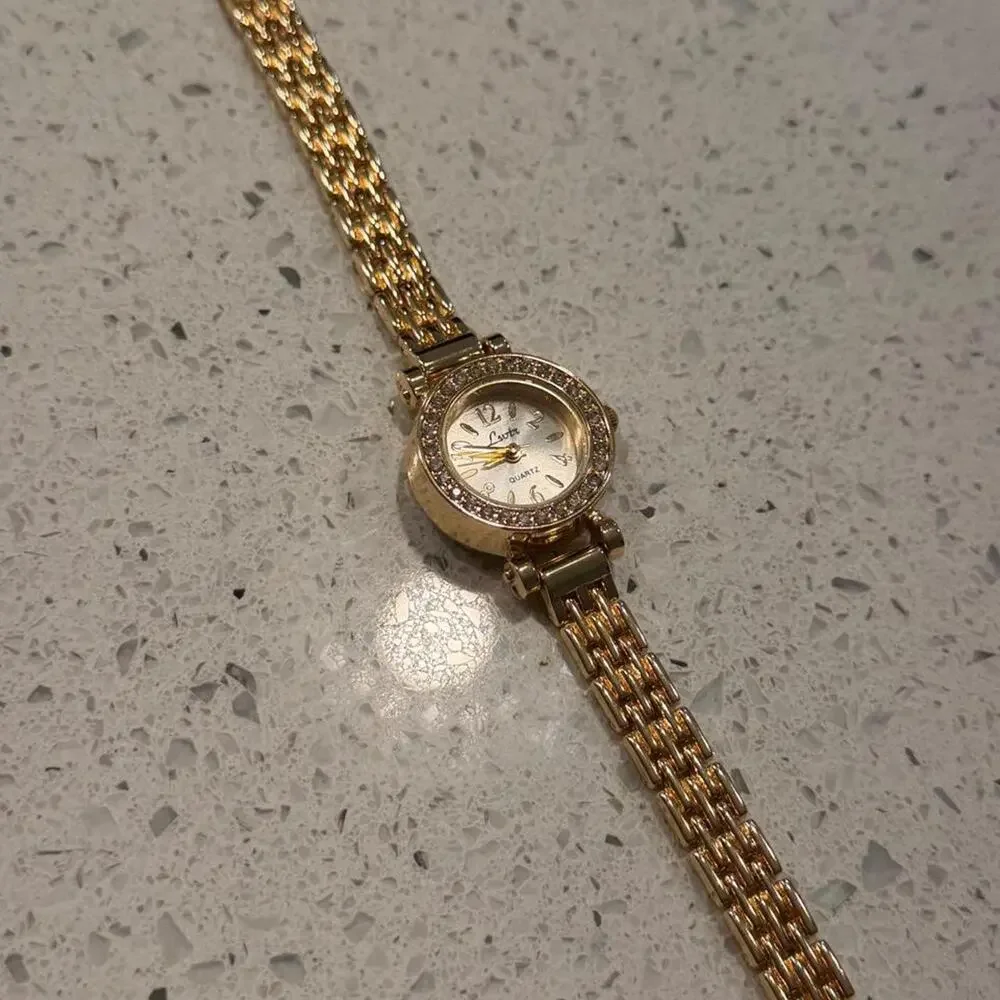 Gold vintage round watch with diamonds